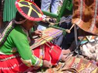 Mujer andina tejiendo artesanalmente